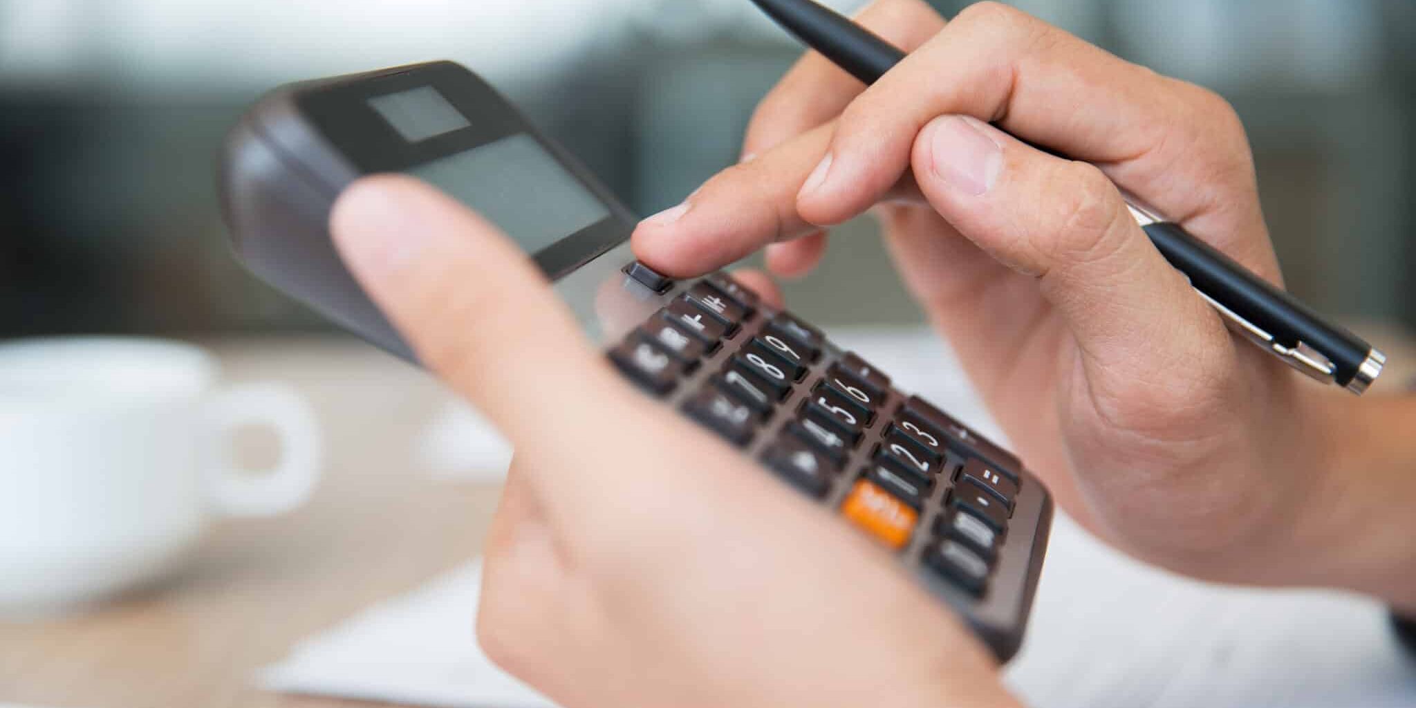 Male hands using calculator